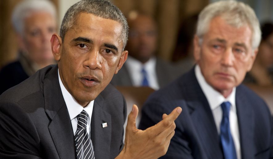 President Obama, seated next to Secretary of Defense Chuck Hagel, speaks to the media about Ebola during a meeting in the Cabinet Room of the White House on Oct. 15, 2014. (AP Photo/Jacquelyn Martin)