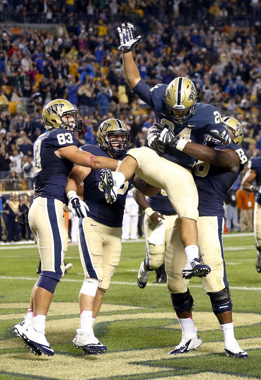 Pittsburgh running back James Conner (24) is lifted by offensive lineman T.J. Clemmings (68) as he celebrates with teammates after scoring in the second quarter of an NCAA football game against Virginia Tech, Thursday, Oct. 16, 2014, in Pittsburgh. (AP Photo/Keith Srakocic)