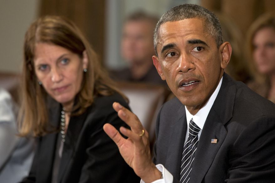 President Barack Obama, right, next to Health and Human Services Secretary Sylvia Burwell, speaks to the media about Ebola during a meeting in the Cabinet Room of the White House in Washington, Wednesday, Oct. 15, 2014, with members of his team coordinating the government’s response to the Ebola outbreak. (AP Photo/Jacquelyn Martin)