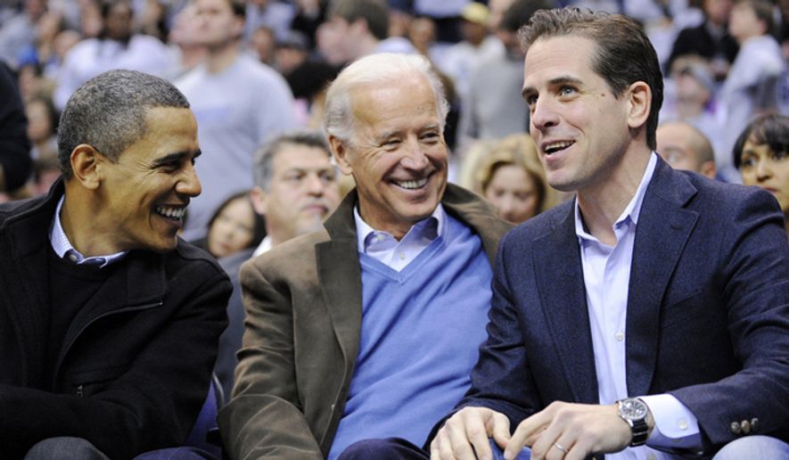 Hunter Biden, right, attends a basketball game with his father, Vice President Joe Biden, center, and President Barack Obama in Washington, D.C., in 2010. (Associated Press) ** FILE **