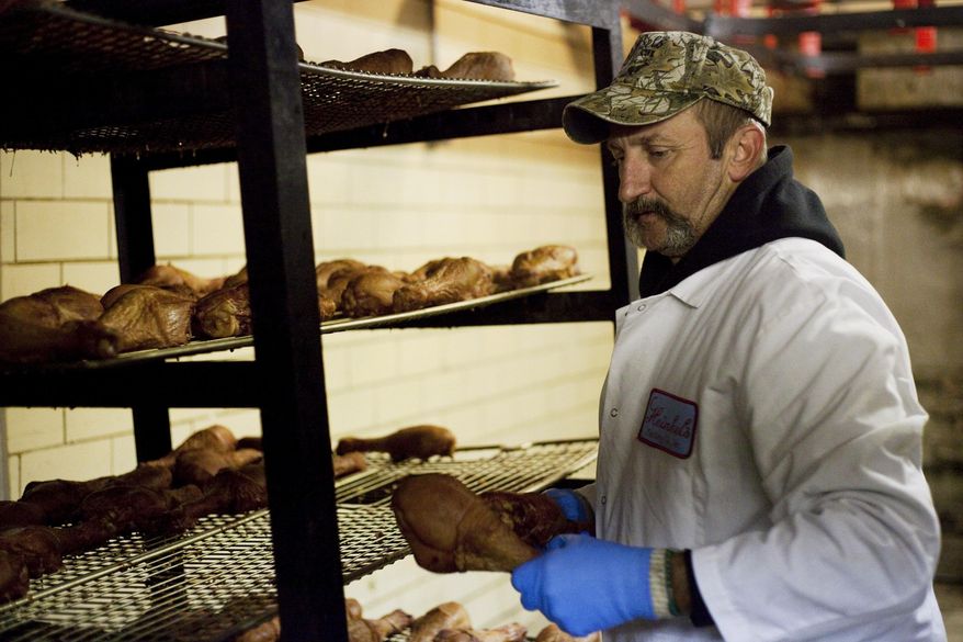 ADVANCE FOR USE SATURDAY, OCT. 18 AND THEREAFTER - In this Sept. 15, 2014 photo, William Hirtman unloads turkey legs from racks at Heinkel’s Packing Co., Inc. where he has been working for five months in Decatur, Ill. Hirtman, 53, of Decatur is about to graduate from Macon County Hybrid Court, a diversion program that gives offenders guilty of nonviolent felonies the substance abuse treatment they need instead of sending them to prison. (AP Photo/Herald & Review, Danny Damiani)