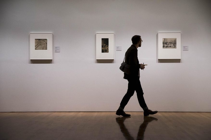 A man views photographs by Paul Strand Thursday, Oct. 16, 2014, during a preview at the Philadelphia Museum of Art in Philadelphia. The exhibition Paul Strand: Master of Modern Photography is scheduled to run from Oct. 21, 2014 to Jan. 4, 2015 (AP Photo/Matt Rourke)