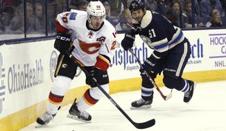 Calgary Flames&#39; Curtis Glencross (20) stays in front of Columbus Blue Jaqckets&#39; Fedor Tyutin (51), of Russia, during the second period of an NHL hockey game, Friday, Oct. 17, 2014, in Columbus, Ohio. The Blue Jackets won 3-2. (AP Photo/Mike Munden)