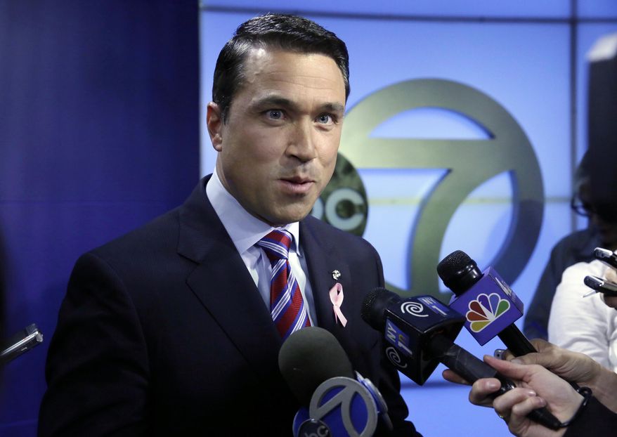Incumbent Republican Rep. Michael Grimm answers reporters' questions after a recorded, televised debate for the 11th Congressional District race with his Democratic challenger Domenic Recchia, Friday, Oct. 17, 2014, at WABC-TV in New York. (AP Photo/Richard Drew)