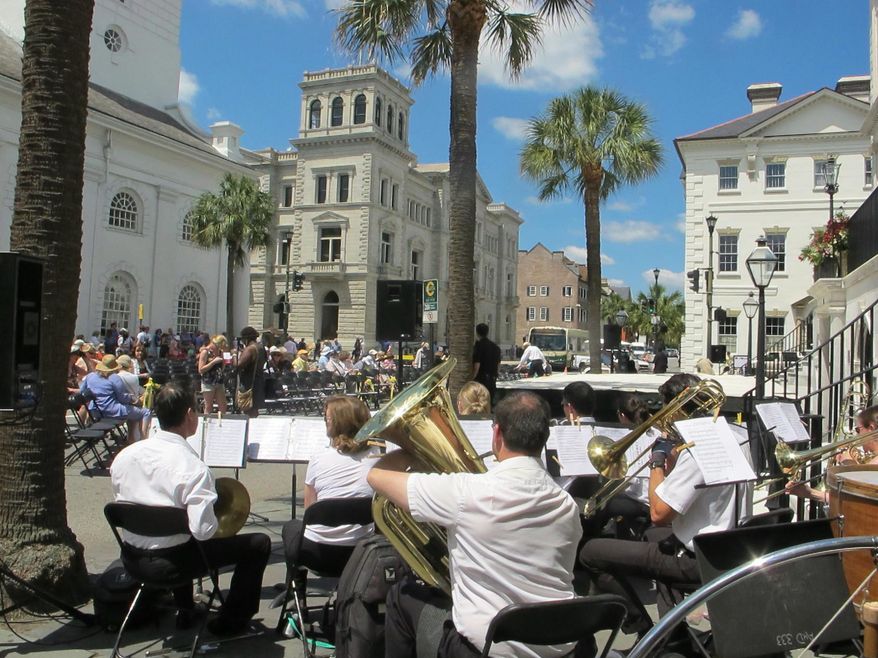 The Charleston Symphony Orchestra Brass Ensemble performs as the audience gathers for the opening ceremonies of the Spoleto Festival USA in Charleston, S.C. Tourism leaders met in Charleston from Oct. 14, 2014 through Oct. 16, 2014 for a meeting of the Southeast Tourism Society. The group said that congressional reauthorization of Brand USA, a program to attract foreign visitors, and fixing the highway infrastructure are key issues in the 12-state region where tourism pumps $210 billion annually into the economy. (AP Photo/Bruce Smith, File)