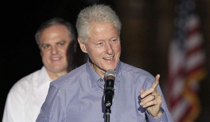 Former President Bill Clinton, right, speaks as fellow Democrat U.S. Sen. Mark Pryor listens at a political rally in Hot Springs, Ark., Friday, Oct.17, 2014. (AP Photo/Danny Johnston)