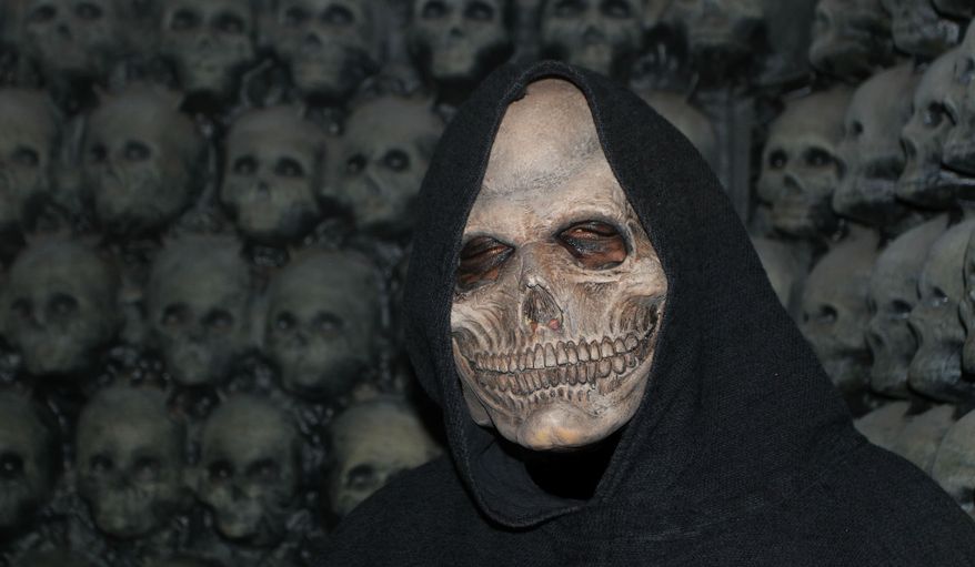 A robed skeleton hides amidst walls of human skulls at Bennett's Curse in Jessup, Maryland. (Photograph by Jacquie Kubin / Special to The Washington Times)