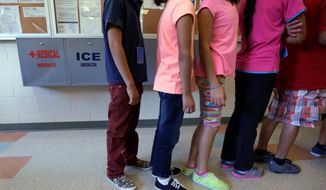 Detained immigrant children line up in the cafeteria at the  Karnes County Residential Center,  a temporary home for immigrant women and children detained at the border, in Karnes City, Texas. (Associated Press)