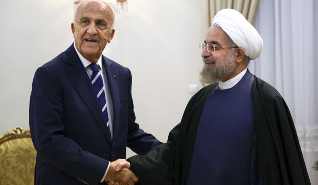 Lebanese Defense Minister Samir Moqbel, left, shakes hands with Iran&#x27;s President Hassan Rouhani at his office in Tehran, Iran, Sunday, Oct. 19, 2014. Moqbel also met other Iranian officials including Ali Shamkhani, Secretary of the Supreme National Security Council. &amp;quot;Iran is ready to transfer its experience in order to improve security in Lebanon and the region, and to combat terrorists,&amp;quot; Shamkhani said during a meeting with Moqbel in Tehran on Sunday. (AP Photo/Ebrahim Noroozi)