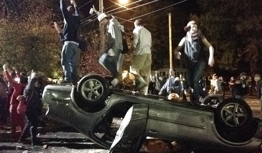 Colin Flaherty rejects equating "white college kids starting bonfires" with Ferguson protestors "attacking police and throwing molotov cocktails." Above: Keene, N.H. pumpkin festival. (AP Photo/The Boston Globe, Jeremy Fox)