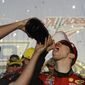 Brad Keselowski drinks champagne after winning the NASCAR Sprint Cup Series auto race at Talladega Superspeedway, Sunday, Oct. 19, 2014, in Talladega, Ala. (AP Photo/Rainier Ehrhardt) 
