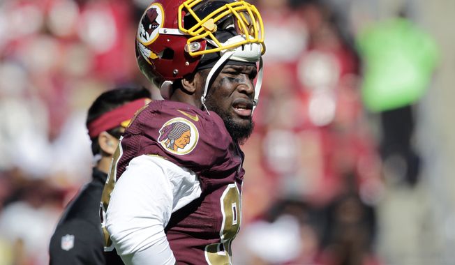 Washington Redskins outside linebacker Brian Orakpo (98) pauses on the field during the first half of an NFL football game against the Tennessee Titans, Sunday, Oct. 19, 2014, in Landover, Md. (AP Photo/Mark E. Tenally)