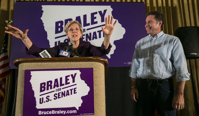 Senate candidate Bruce Braley, right,  campaigns with  U.S. Sen. Elizabeth Warren, D-Mass., in an Iowa Votes rally in Des Moines  Sunday, Oct. 19, 2014, at the Hotel Fort Des Moines . (AP Photo/The Des Moines Register, Rodney White)  MAGS OUT, TV OUT, NO SALES, MANDATORY CREDIT
