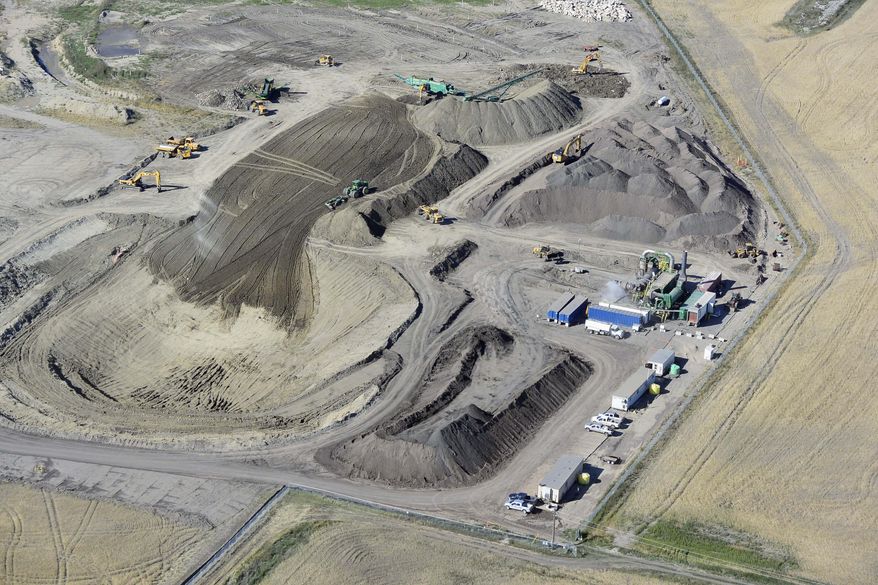 This September 2014 photo provided by Tesoro Corp., shows the site where around-the-clock cleanup continues one year after 20,000 barrels of oil spilled from a Tesoro pipeline break onto a farmer’s field in northwestern North Dakota near Tioga. The massive spill has been called the worst in state history. Tesoro blames a lightning strike for causing the rupture. (AP Photo/Courtesy of Tesoro Corp.)