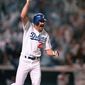 Los Angeles Dodgers Kirk Gibson raises his arm in celebration as he rounds the bases after hitting a game-winning two-run home run in the bottom of the ninth inning to beat the Oakland A&#39;s 5-4 in the first game of the World Series at Dodger Stadium Oct. 15, 1988.  (AP Photo/Rusty Kennedy)