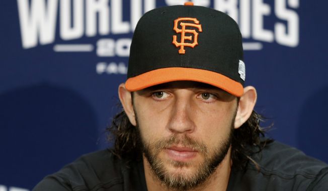 San Francisco Giants starting pitcher Madison Bumgarner talks to the media before baseball practice Monday, Oct. 20, 2014, in Kansas City, Mo. The Kansas City Royals will host the San Francisco Giants in Game 1 of the World Series on Oct. 21. (AP Photo/Orlin Wagner)