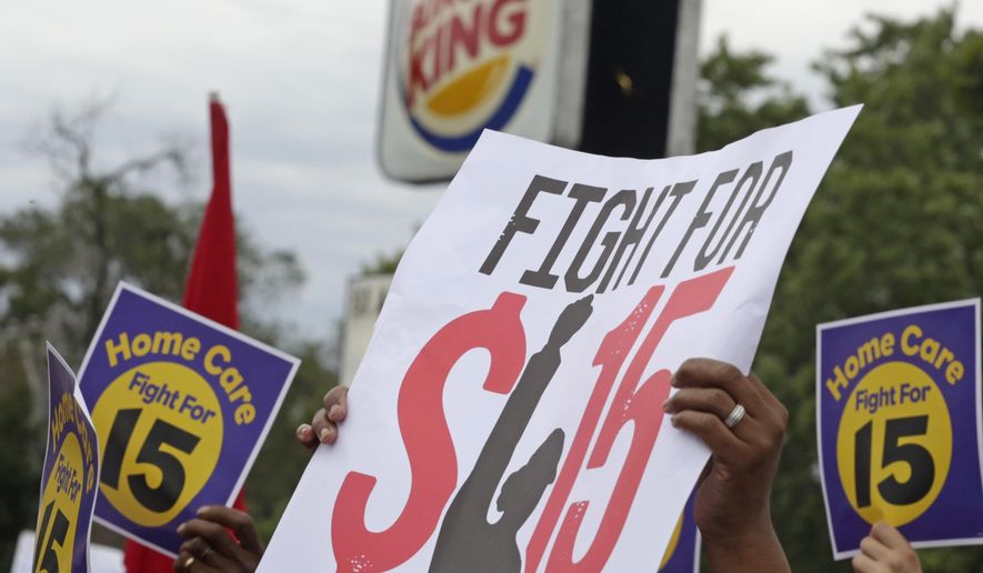 FILE - In this Sept. 14, 2014 file photo,  protesters participate in a rally outside a Burger King on Chicago&#39;s south side as labor organizers escalate their campaign raise the minimum wage for employees to $15 an hour. As Democrats across the country make an election-year push to raise the minimum wage, they are also looking to motivate younger people, minorities and others in their base to go to the polls on Nov. 4th. The party has put questions on the ballot in five states asking voters whether the minimum wage should be increased. (AP Photo/M. Spencer Green, File) **FILE**