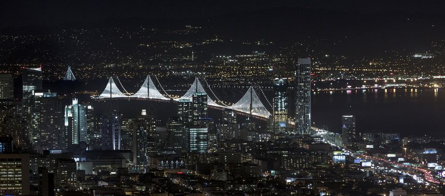 This image provided by James Ewing via the Cultural Landscape Foundation shows the San Francisco-Oakland Bay bridge. New York artist Leo Villareal created his largest light installation on the San Francisco-Oakland Bay Bridge in March 2013. It was initially contracted as a two-year project ending in 2015 as the bridge will undergo maintenance. Now the installation is among 11 sites being listed as endangered landscapes by the Cultural Landscape Foundation. A campaign is underway to keep the project funded through 2026. (AP Photo/James Eqing via the cultural Landscape Foundation)