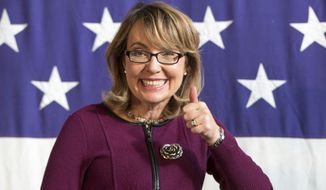 FILE - This Oct. 27, 2013, file photo, shows former U.S. Rep. Gabby Giffords (D-Ariz.), at a fundraiser for U.S. Senate candidate Bruce Braley at the Iowa State Fairgrounds in Des Moines, Iowa. As the race between Rep. Ron Barber D- Ariz., who also was wounded in the 2011 shooting, and Republican Martha McSally has grown tighter in the final weeks before the Nov. 4, 2014, elections, Giffords is playing more of a role by appearing in ads and raising money for her former aide and increasingly turning the race into a debate about guns. (AP Photo/Scott Morgan, File)