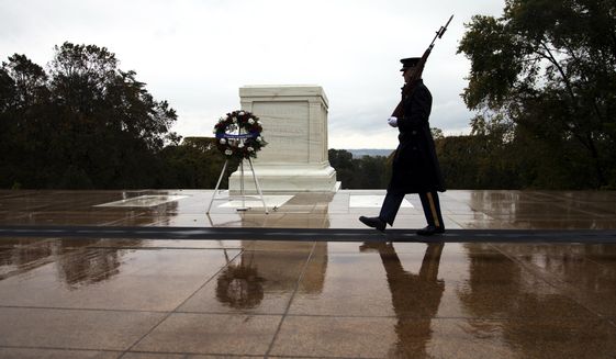 Tomb guards walks at the Tomb of the Unknown Soldier in Arlington National Cemetery in Arlington, Va., Wednesday, Oct. 22, 2014. (AP Photo/Manuel Balce Ceneta)  ** FILE **