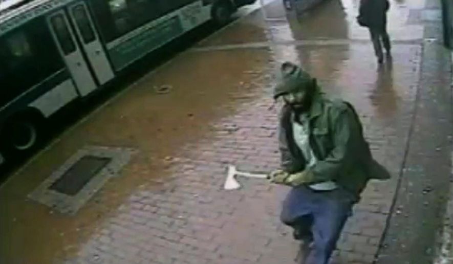 In this frame grab taken from video provided by the New York Police Department, an unidentified man approaches New York City police officers with a hatchet, Thursday, Oct. 23, 2014, in the Queens borough of New York. The man injured two with the hatchet before the other officers shot and killed him, police said. A bystander was wounded in the gunfire. Investigators were still trying to confirm the identity of the assailant and determine a motive. (AP Photo/New York Police Department)