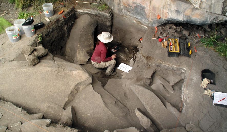 This undated image provided by journal Science shows Sonia Zarriollo during an excavation at Cuncaicha rock shelter in the Peruvian Andes. Stone tools and other artifacts have revealed the presence of hunter-gatherers at about 14,700 feet above sea level, between 12,000 and 12,500 years ago in the Peruvian Andes. (AP Photo/Science, Kurt Rademaker)