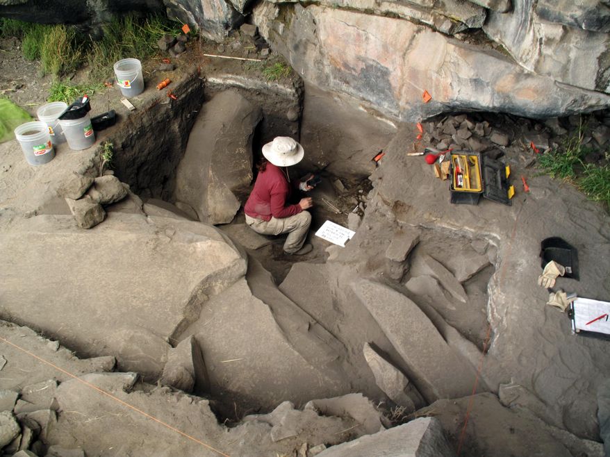 This undated image provided by journal Science shows Sonia Zarriollo during an excavation at Cuncaicha rock shelter in the Peruvian Andes. Stone tools and other artifacts have revealed the presence of hunter-gatherers at about 14,700 feet above sea level, between 12,000 and 12,500 years ago in the Peruvian Andes. (AP Photo/Science, Kurt Rademaker)