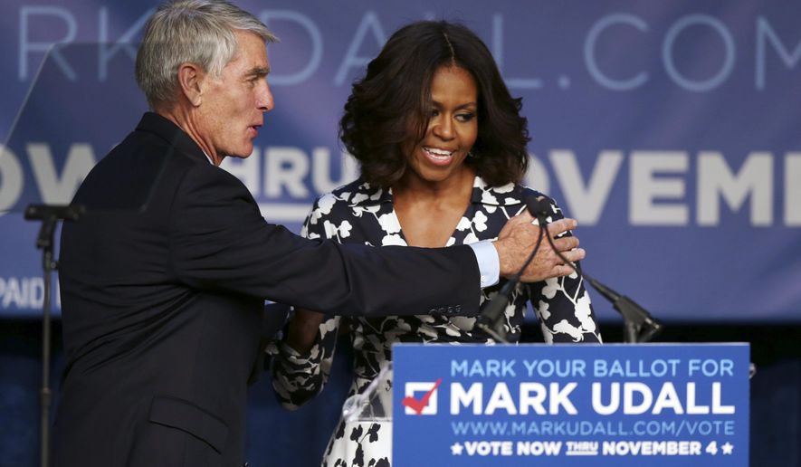 First lady Michelle Obama, right, is thanked by Sen. Mark Udall, D-Colo., after rally for his re-election campaign in Denver on Thursday, Oct. 23, 2014. Obama will make another stop on Thursday when she appears at a rally for Udall&#39;s campaign in Moby Arena on the campus of Colorado State University in Fort Collins, Colo. (AP Photo/David Zalubowski)