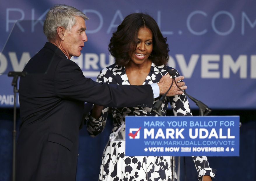 First lady Michelle Obama, right, is thanked by Sen. Mark Udall, D-Colo., after rally for his re-election campaign in Denver on Thursday, Oct. 23, 2014. Obama will make another stop on Thursday when she appears at a rally for Udall&#39;s campaign in Moby Arena on the campus of Colorado State University in Fort Collins, Colo. (AP Photo/David Zalubowski)