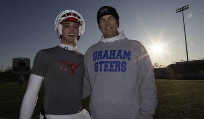 Colt McCoy&#x27;s father, Brad, is pictured in a Dec. 16, 2009, photo with his son, Case, also a quarterback, in Graham, Texas. (AP Photo/LM Otero)
