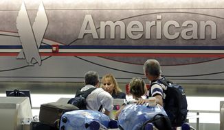 In this photo taken Tuesday, May 27, 2014, passengers check in at the American Airlines counter at Miami International Airport in Miami. American Airlines reports quarterly financial results on Thursday, Oct. 23, 2014. (AP Photo/Alan Diaz)