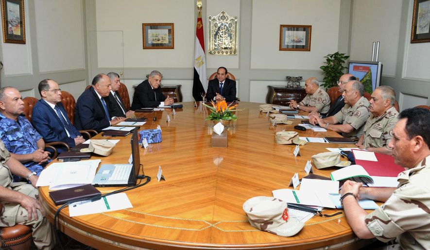 In this photo provided by Egypt's state news agency MENA, Egypt's President Abdel-Fattah el-Sissi, center, holds an emergency meeting of the National Defense Council with top officials after an attack in the Sinai Peninsula, in Cairo, Egypt, Friday, Oct. 24, 2014. The coordinated assault on an army checkpoint in the Sinai Peninsula killed 30 Egyptian troops on Friday, making it the deadliest single attack in decades on the military, which has been struggling to stem a wave of violence by Islamic extremists since the overthrow of Islamist President Mohammed Morsi. El-Sissi, the former defense minister and army chief who overthrew Morsi last year, declared a three-day mourning period. (AP Photo/MENA)