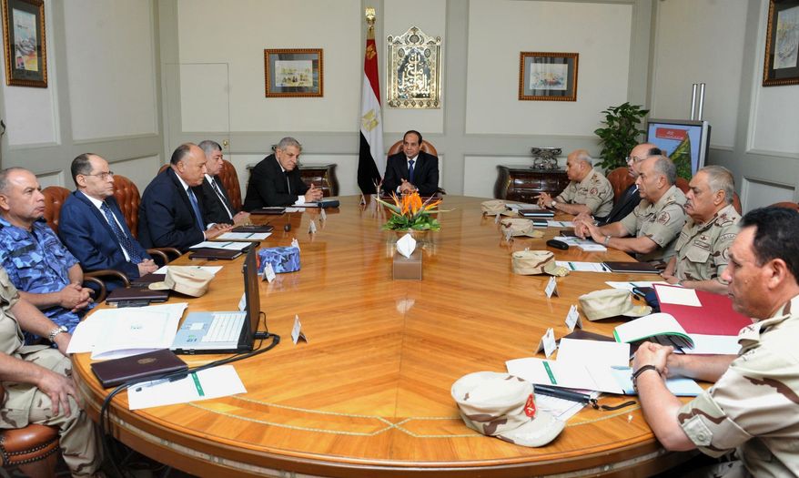 In this photo provided by Egypt's state news agency MENA, Egypt's President Abdel-Fattah el-Sissi, center, holds an emergency meeting of the National Defense Council with top officials after an attack in the Sinai Peninsula, in Cairo, Egypt, Friday, Oct. 24, 2014. The coordinated assault on an army checkpoint in the Sinai Peninsula killed 30 Egyptian troops on Friday, making it the deadliest single attack in decades on the military, which has been struggling to stem a wave of violence by Islamic extremists since the overthrow of Islamist President Mohammed Morsi. El-Sissi, the former defense minister and army chief who overthrew Morsi last year, declared a three-day mourning period. (AP Photo/MENA)