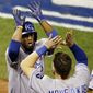 Kansas City Royals&#x27; Alcides Escobar is congratulated by teammate Mike Moustakas after scoring during the sixth inning of Game 3 of baseball&#x27;s World Series against the San Francisco Giants Friday, Oct. 24, 2014, in San Francisco. (AP Photo/Eric Risberg) 