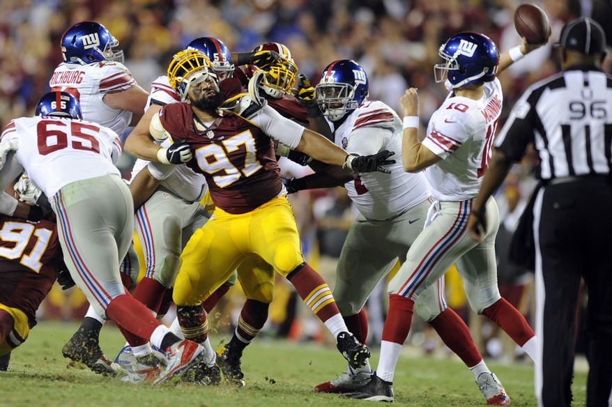 Washington Redskins defensive end Jason Hatcher (97) fights to get to New York Giants quarterback Eli Manning (10) in the third quarter at FedExField, Landover, Md., Sept. 25, 2014. (Preston Keres/Special for The Washington Times)