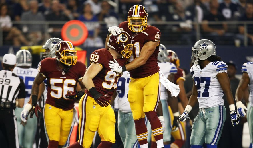 Washington Redskins&#39; Ryan Kerrigan, top, celebrates with Trent Murphy (93) after Murphy recovered a Dallas Cowboys fumble during the first half of an NFL football game, Monday, Oct. 27, 2014, in Arlington, Texas. (AP Photo/Tim Sharp)