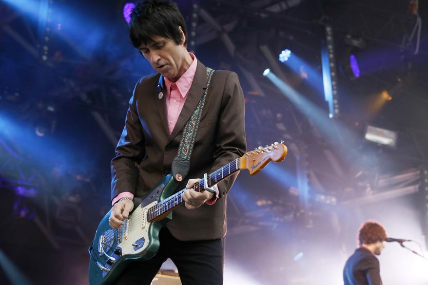 FILE - In this Aug. 1, 2014 file photo, British singer Johnny Marr performs at Camp Bestival at Lulworth Castle in Dorset, England.The former guitarist for The Smiths has just released his second solo album, "Playland," a follow-up to well-received 2013 effort "The Messenger." Both offer robust, richly textured guitar rock _ the latest of Marr's many musical modes. (Photo by Jim Ross/Invision/AP, File)