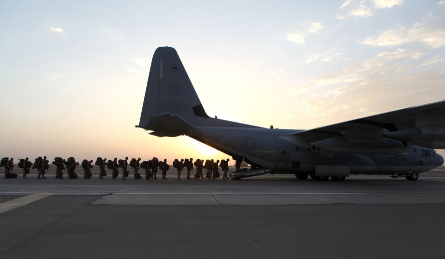 This handout photo provided Defense Department shows Marines and sailors with Marine Expeditionary Brigade – Afghanistan load onto a KC-130 aircraft on the Camp Bastion, Afghanistan flightline, Monday, Oct. 27, 2014. The handover of the U.S. Marines' main base to Afghan control in the hardscrabble Helmand province is more than a signal that America’s longest war is ending. It is a reminder of the enormous loss and sacrifice by Marines who swept in as part of President Barack Obama’s surge of forces against a resurgent Taliban in 2009. (AP Photo/Staff Sgt. John Jackson, Defense Department, US Marines)