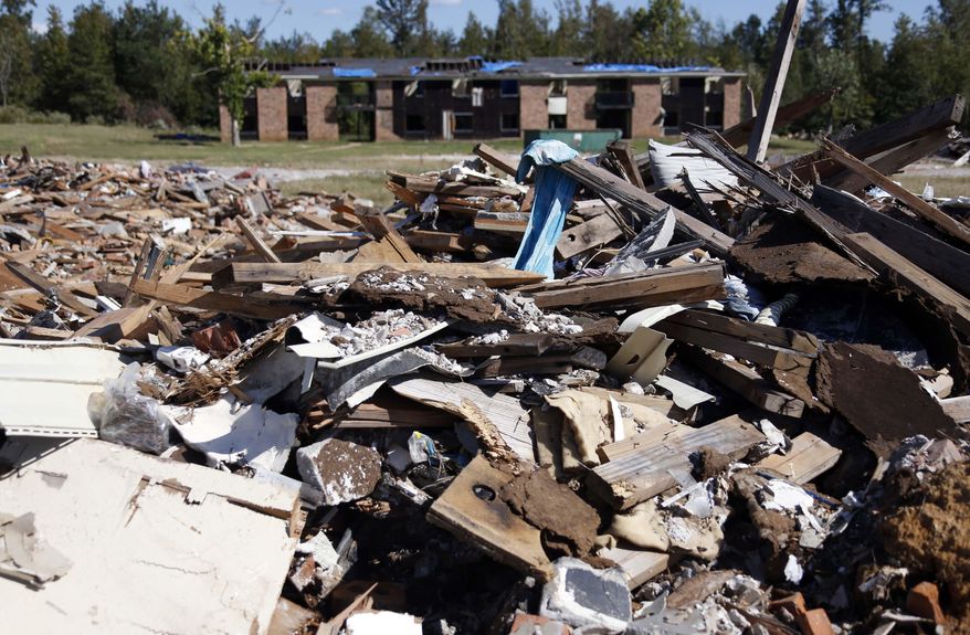 In this Oct. 15, 2014 photo, a final set of apartments at the Eiland Plaza Apartments complex in Louisville, Miss., awaits a wrecker's ball to finish off what a tornado did earlier this year. Six months after a devastating tornado, Winston County’s hospital is still operating out of tents and shipping containers, home rebuilding is sputtering along and it may be another year before a new plywood mill opens. Still, local leaders say they’re optimistic about rebounding from the April 28 twister, (AP Photo/Rogelio V. Solis)