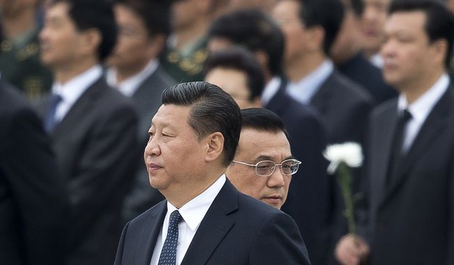 In this file photo taken Tuesday, Sept. 30, 2014, Chinese Premier Li Keqiang, right, walks past Chinese President Xi Jinping as they arrive at the Monument to the People&#x27;s Heroes during a ceremony marking Martyr&#x27;s Day at Tiananmen Square in Beijing, China. Afghan President Ashraf Ghani Ahmadzai travels to China on Tuesday, Oct. 28, signaling the pivotal role he hopes Beijing will play in Afghanistan&#x27;s future, not only in the economic reconstruction of his war-ravaged country after U.S. and allied combat troops leave by the end of the year but also in a strategic foreign policy aimed at building peace across a region long riven by mistrust and violence. (AP Photo/Andy Wong, File)
