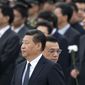 In this file photo taken Tuesday, Sept. 30, 2014, Chinese Premier Li Keqiang, right, walks past Chinese President Xi Jinping as they arrive at the Monument to the People&#39;s Heroes during a ceremony marking Martyr&#39;s Day at Tiananmen Square in Beijing, China. Afghan President Ashraf Ghani Ahmadzai travels to China on Tuesday, Oct. 28, signaling the pivotal role he hopes Beijing will play in Afghanistan&#39;s future, not only in the economic reconstruction of his war-ravaged country after U.S. and allied combat troops leave by the end of the year but also in a strategic foreign policy aimed at building peace across a region long riven by mistrust and violence. (AP Photo/Andy Wong, File)