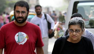 Egypt’s most prominent activist Alaa Abdel-Fattah, left, walks with his mother Laila Soueif, a university professor who is an also an activist, outside a court that convicted 23 activists of staging an illegal demonstration and sentenced them each to three years in jail, in Cairo, Egypt, Sunday, Oct. 26, 2014. Among the 23 is Sanaa Seif, who hails from a family of longtime rights campaigners, including her late father Ahmed Seif al-Dawla and brother Alaa Abdel-Fattah. Another defendant is Yara Sallam, a prominent rights lawyer. Sunday&#x27;s verdicts, which can be appealed, comes at a time when Egypt is swept by nationalist sentiments following a dramatic surge in attacks blamed on Islamic militants on troops and security forces in the Sinai Peninsula while witnessing a smear campaign targeting many of the secular pro-democracy campaigners behind the 2011 uprising. (AP Photo/Hussein Tallal)