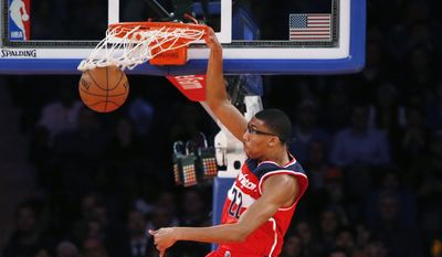 Washington Wizards forward Otto Porter Jr. (22) dunks in front of New York Knicks guard Shane Larkin (0) in the first half of an NBA basketball game at Madison Square Garden in New York, Wednesday, Oct. 22, 2014. (AP Photo/Kathy Willens)