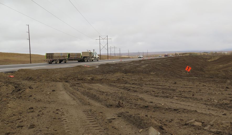 Road construction is seen alongside U.S. Highway 85 near Alexander, N.D. on Tuesday, Oct. 28, 2014. A recently completed bypass has diverted heavy traffic from the small town. (AP Photo/Josh Wood)