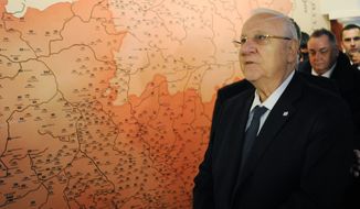 Israeli President Reuven Rivlin walks past a historical map of Poland as he tours the POLIN Museum of the History of Polish Jews during the opening of the core exhibition, in Warsaw, Poland, Tuesday, Oct. 28, 2014. (AP Photo/Alik Keplicz)