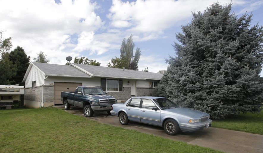 FILE - In this, Sept. 28, 2014, file photo, shows the home where five Utah family members found dead in their home, in Springville, Utah. Police say the deaths of five members of a Utah family whose bodies were found last month do not appear to be accidental or natural. Court documents obtained Wednesday show the five members of the Strack family, including three children, were found in their Springville home, covered in bedding with cups of red liquid next to the bodies. (AP Photo/Rick Bowmer, File)