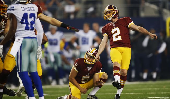 Washington Redskins kicker Kai Forbath (2) watches his kick go through the uprights for an extra point during the first half of an NFL football game against the Dallas Cowboys, Monday, Oct. 27, 2014, in Arlington, Texas. Washington won 20-17 in overtime. (AP Photo/Tim Sharp)