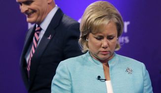 Sen. Mary Landrieu, D-La., and Rep. Bill Cassidy, R-La., take their places to participate in a Senate race debate with and Republican candidate and Tea Party favorite Rob Maness on the LSU campus in Baton Rouge, La., Wednesday, Oct. 29, 2014. (AP Photo/Gerald Herbert)