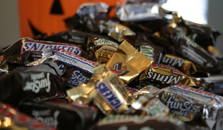 FILE - This Sept. 30, 2007 file photo shows "Fun Size" and "Mini" candies in New York. The cost of the ingredients in chocolate is rising, and the nation’s biggest candy makers have already warned that shoppers are going to see price hikes in 2015. (AP Photo/Dan Goodman, File)