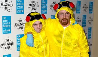 Filmmaker Guy Ritchie and his son Rocco go with the &quot;Breaking Bad&quot; trend this Halloween, just one of the costumes that push the boundaries of taste. (Associated Press)